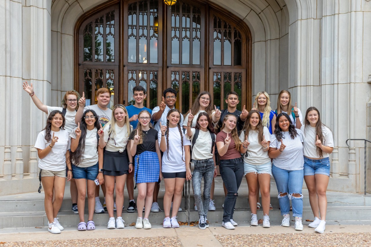 Group of Sooner Discovery students posing in front of doors of Bizzell Memorial Library