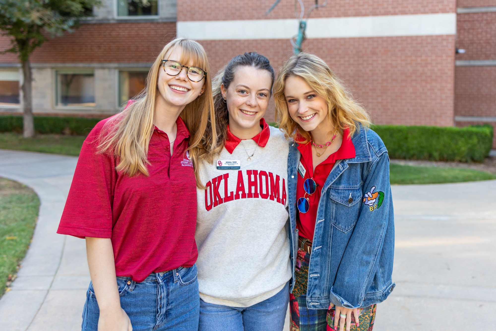 Three student workers at OU event