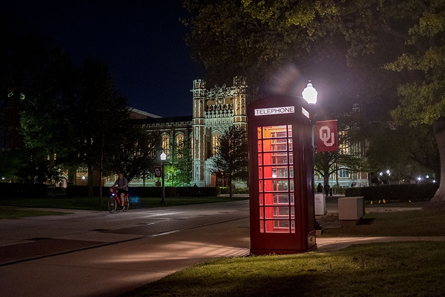 Phone booth lit up on campus at night