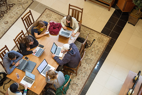 Students sitting in a common area in Gaylord College.