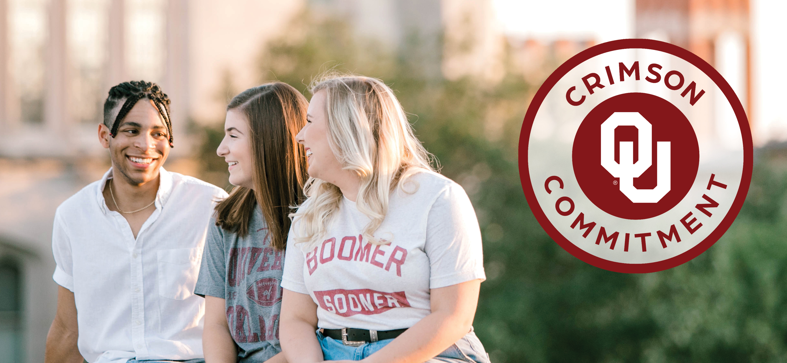 Crimson Commitment: Three students talking on OU campus