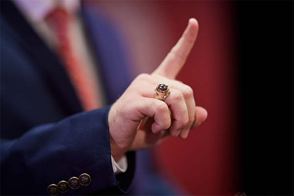 Persons hand holding up the number one, wearing an OU class ring