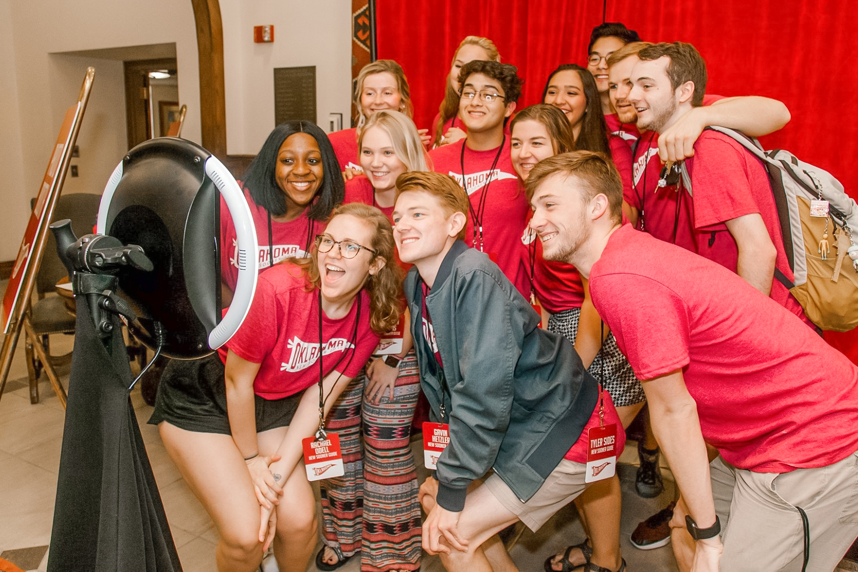 Students taking a group photo in a photo booth at New Student Orientation.