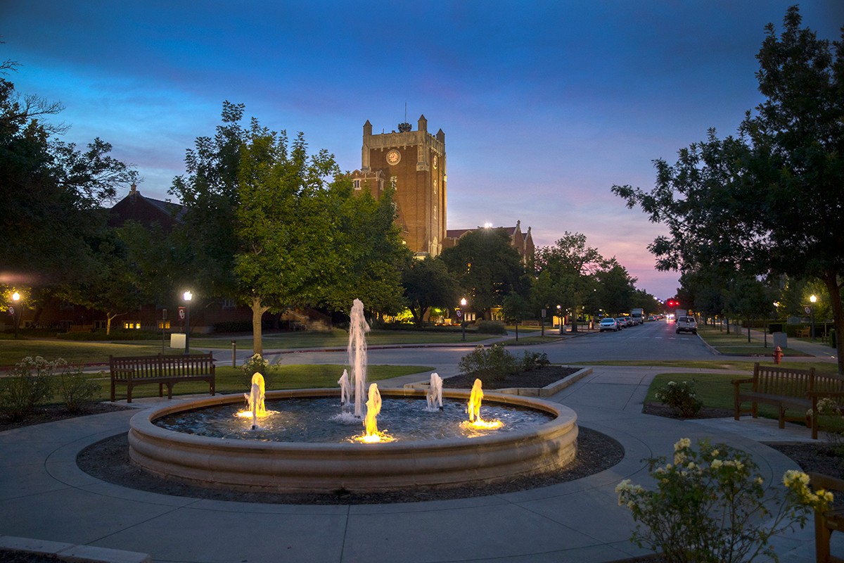 View from Price College fountain looking north to the OMU clock tower at sunset