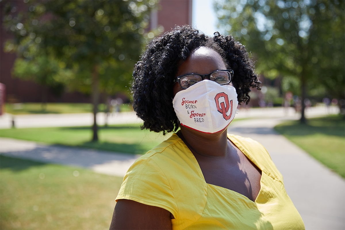 Student wearing a mask on the south oval