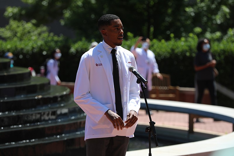 Speaker stands at microphone at OU HSC Black Lives Matter Event