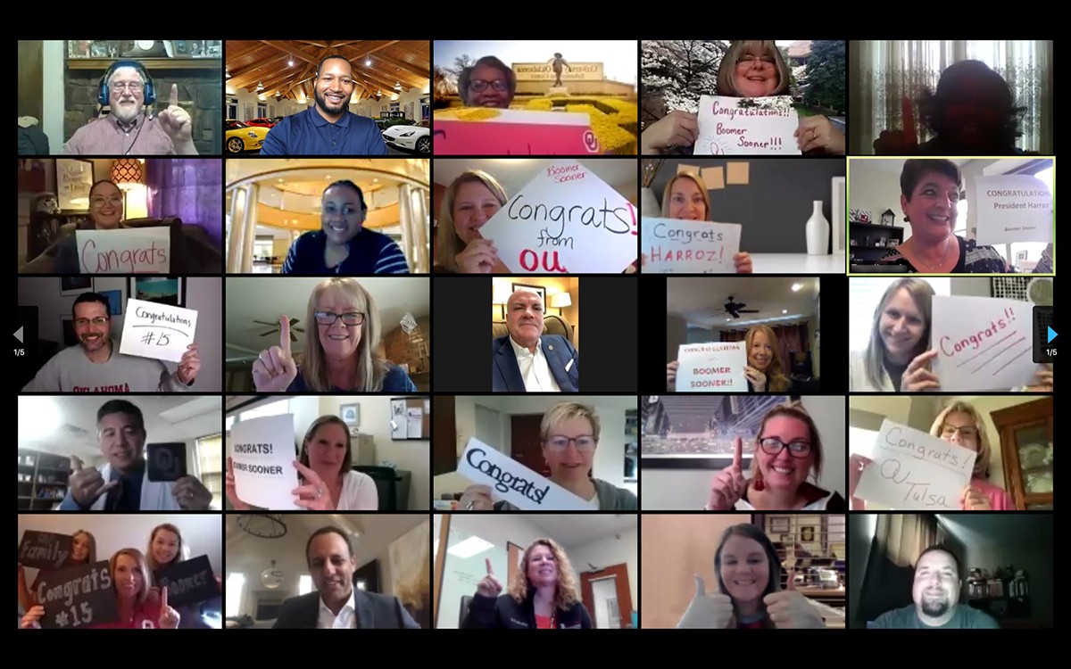 Grid of people holding up congradulatory signs and hand gestures in Zoom call