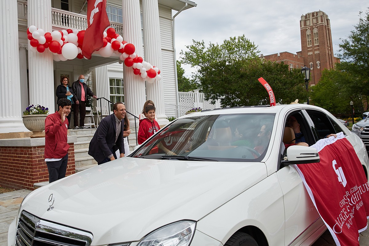 President Harroz greets individuals from their cars at welcome wave event