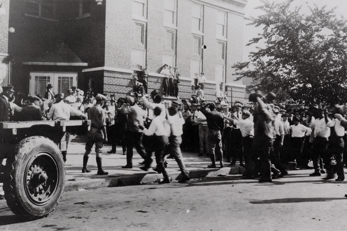 Men being led into Convention Hall located at 101 West Brady Street for internment during the Tulsa Race Massacre on June 1, 1921. Image Credit: Tulsa Historical Society and Museum
