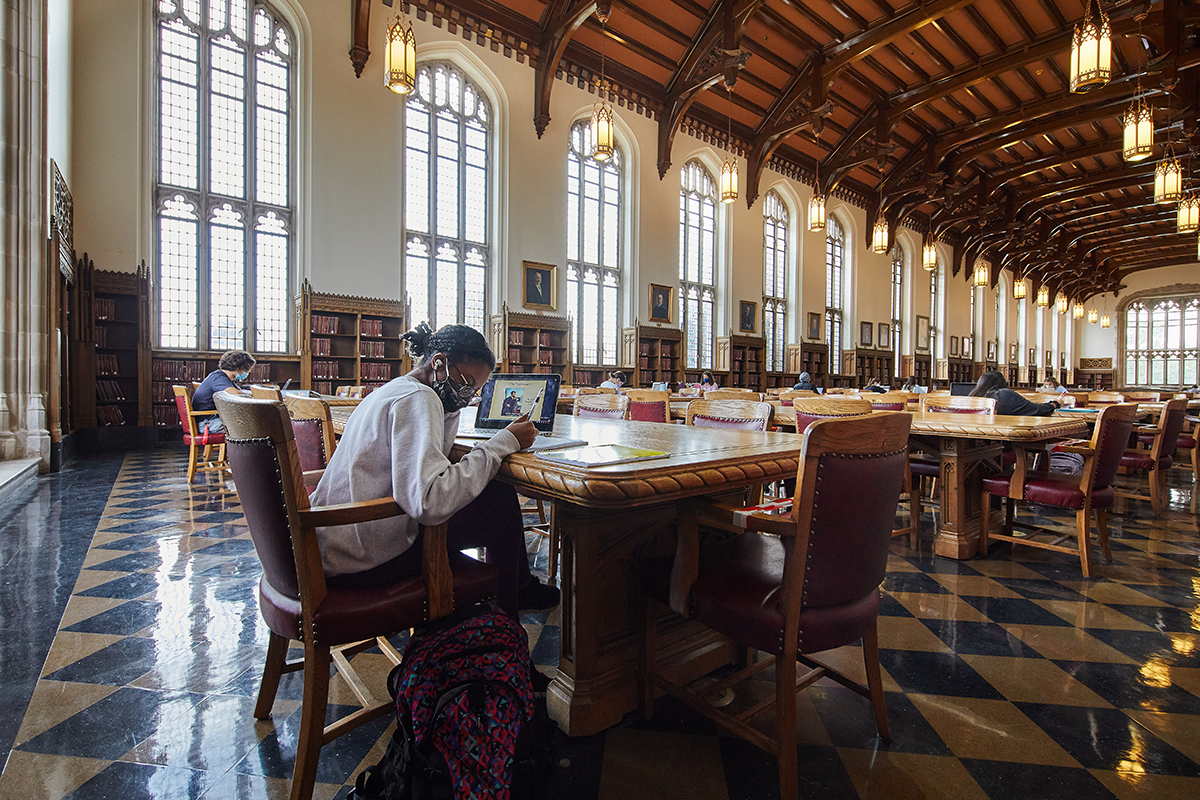 OU Student, masked, studies in the Great Reading Room on OU Campus