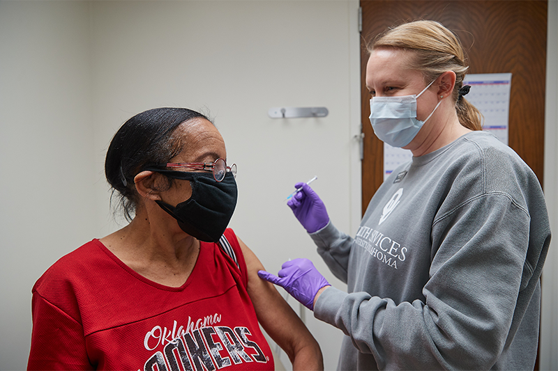 Photo of a nurse administering the COVID-19 vaccine to a patient at Goddard Health Center.