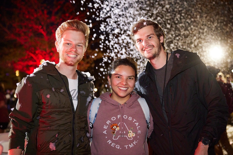 Students pose together under flurries of faux bubble snow