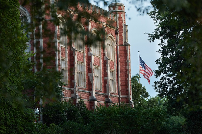 An American flag waving in the breeze outside Evans Hall