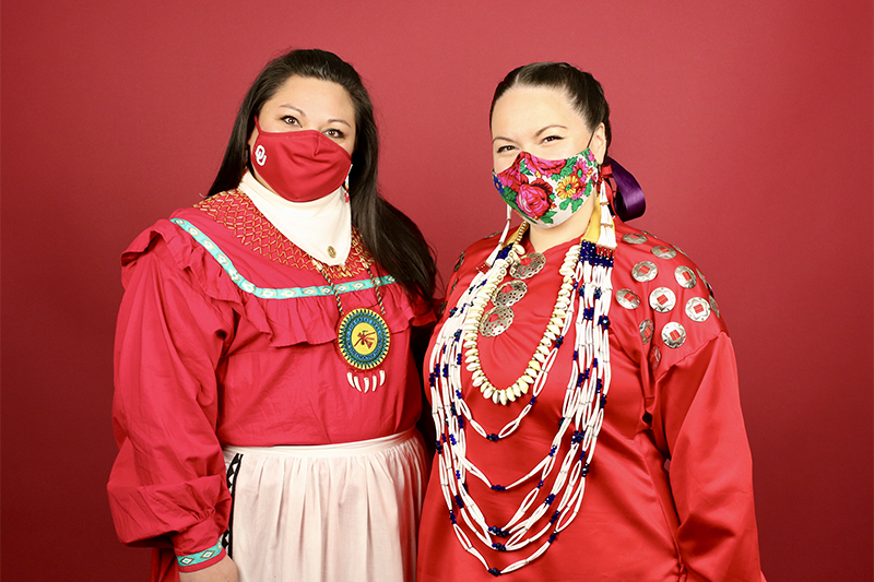 COVID masked women in tribal attire pose for a portrait
