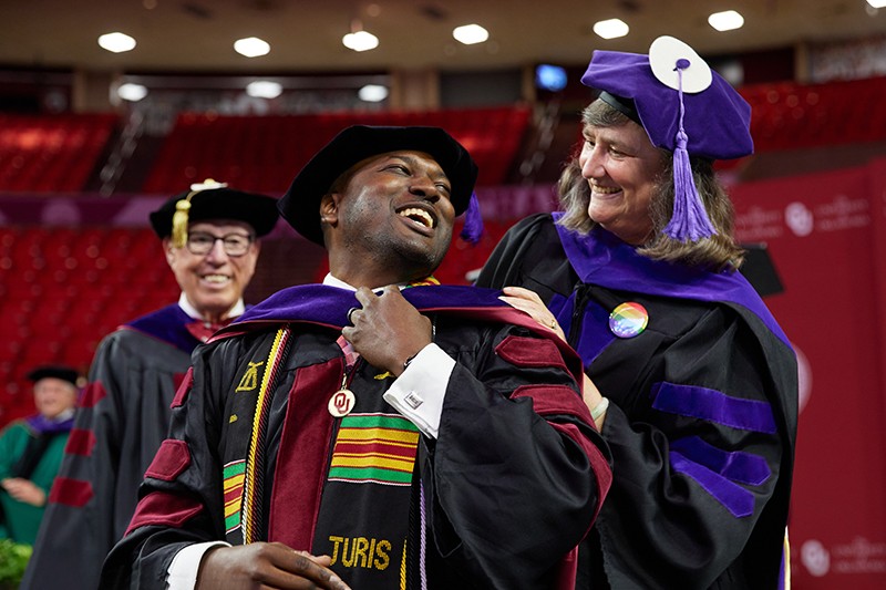Student is hooded by professor at LNC ceremony