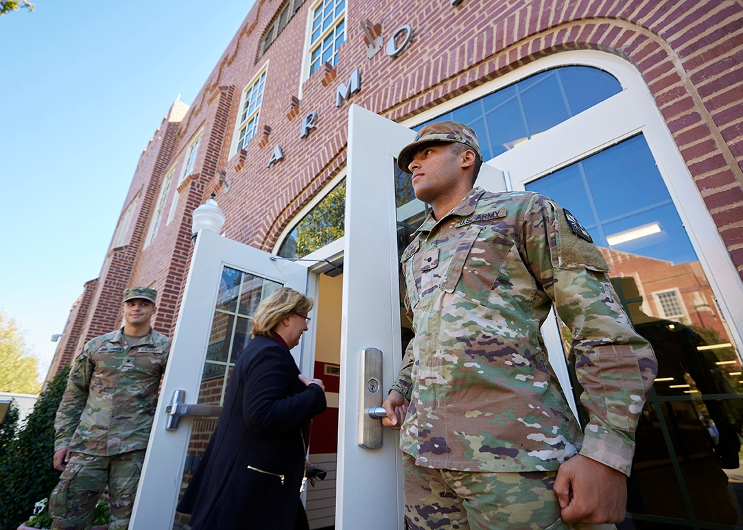 ROTC students hold open doors for guests at the armory