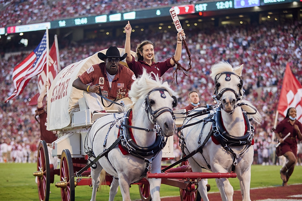 Boomer and Sooner ponies pull the schooner with two Ruf Neks aboard