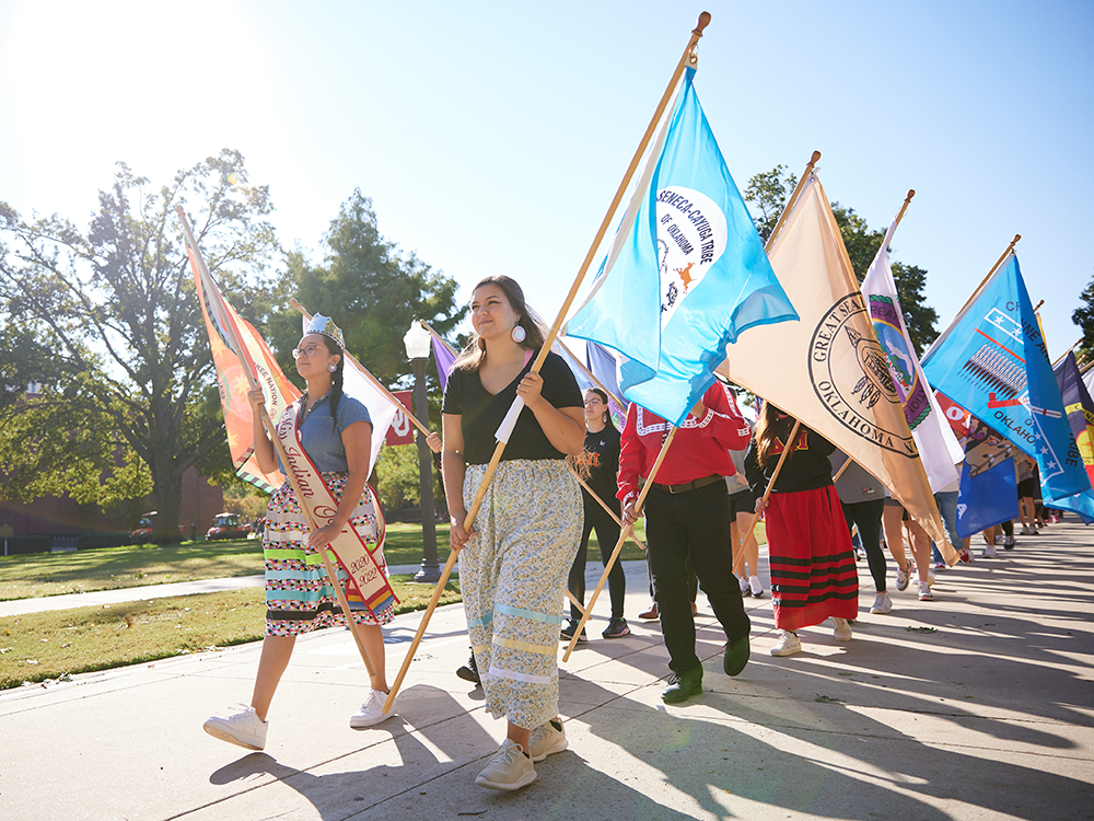 Students, Staff and OU community members parade with flags for Indigenous Peoples Day