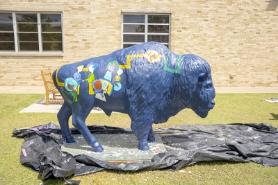 bison sculpture painted with geometric design