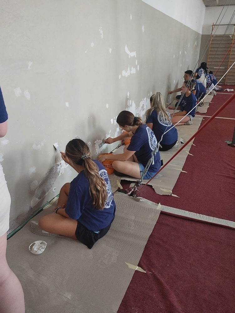 students patch a wall