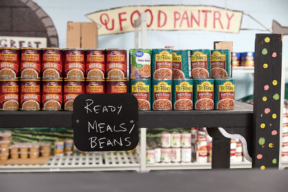 Cans of food lined up on shelf at the OU Food Pantry