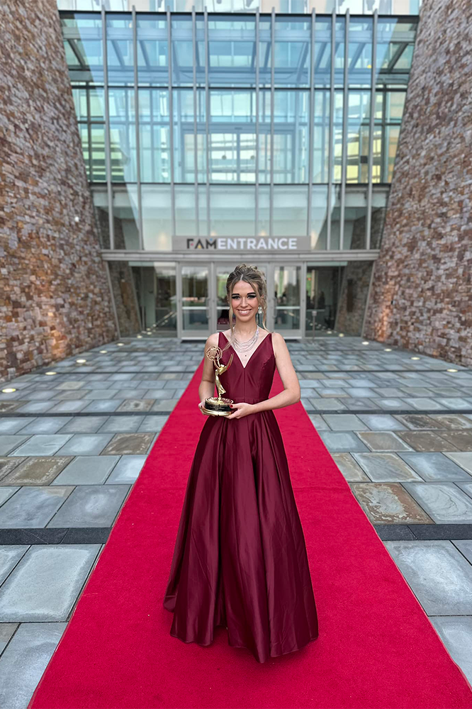 Shiloh Sellers poses with her Emmy on a red carpet