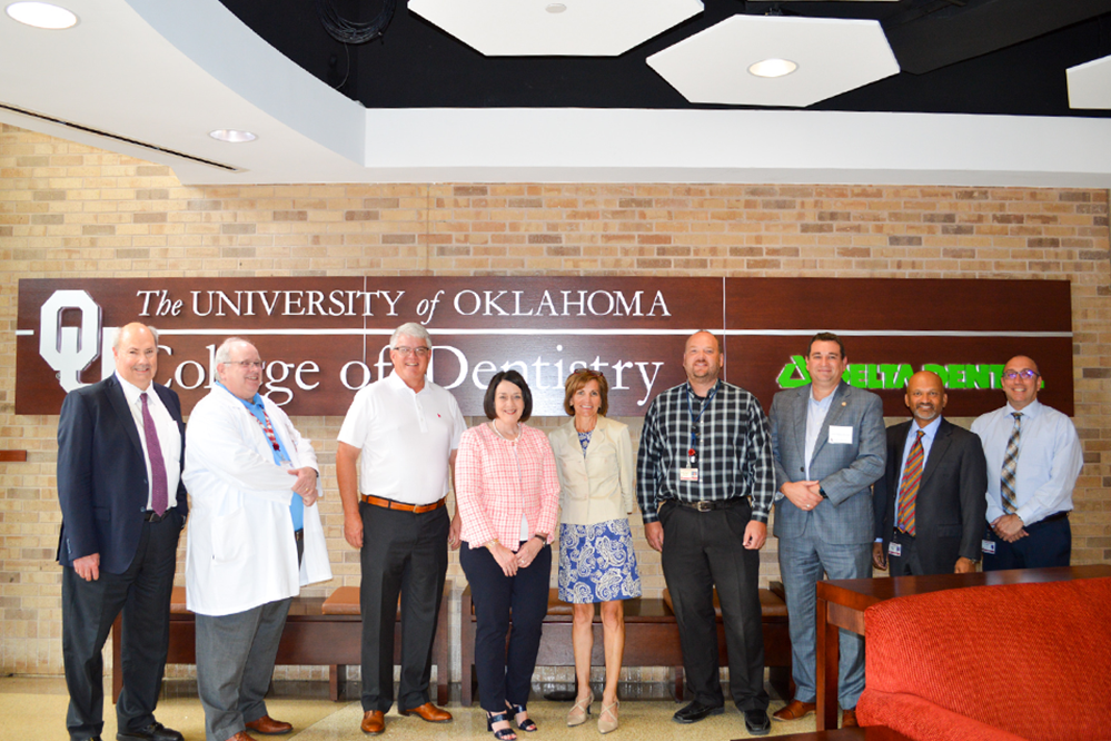 regents pose for photo at the college of dentistry