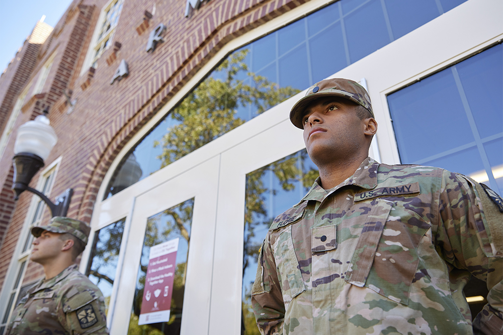 ROTC students in uniform flank the doors to the OU Armory building