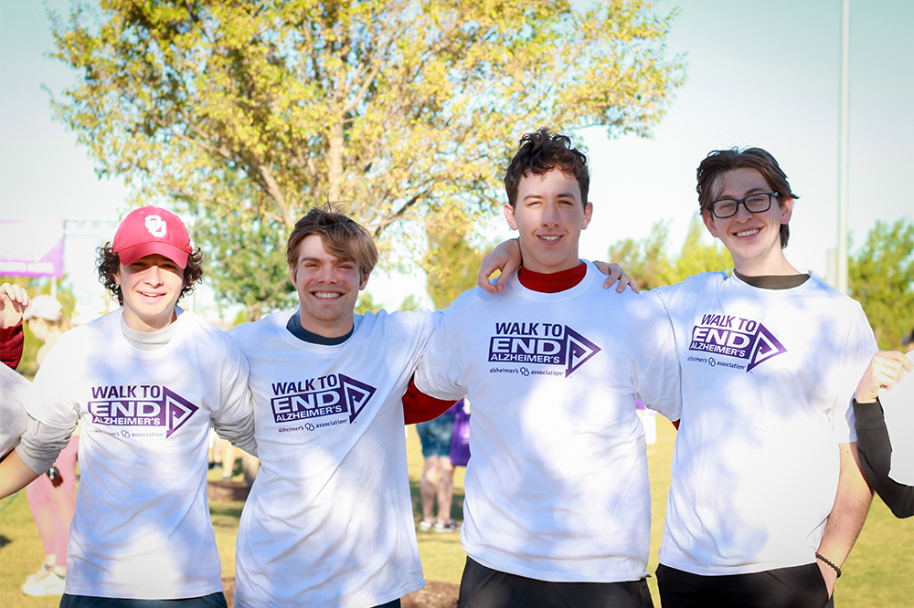 4 students pose for a photo wearing Walk to End Alzheimers tees