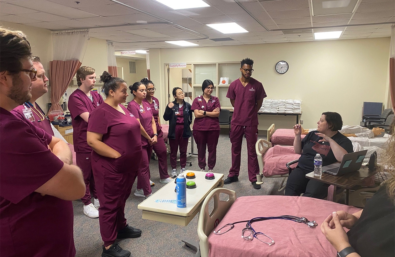 students stand and listen to lecture in clinical setting