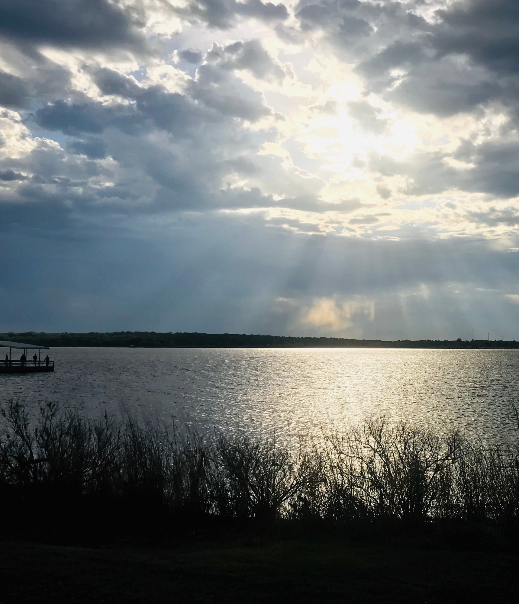 Blue sunrise over lake. dr bedle and students at graduation.