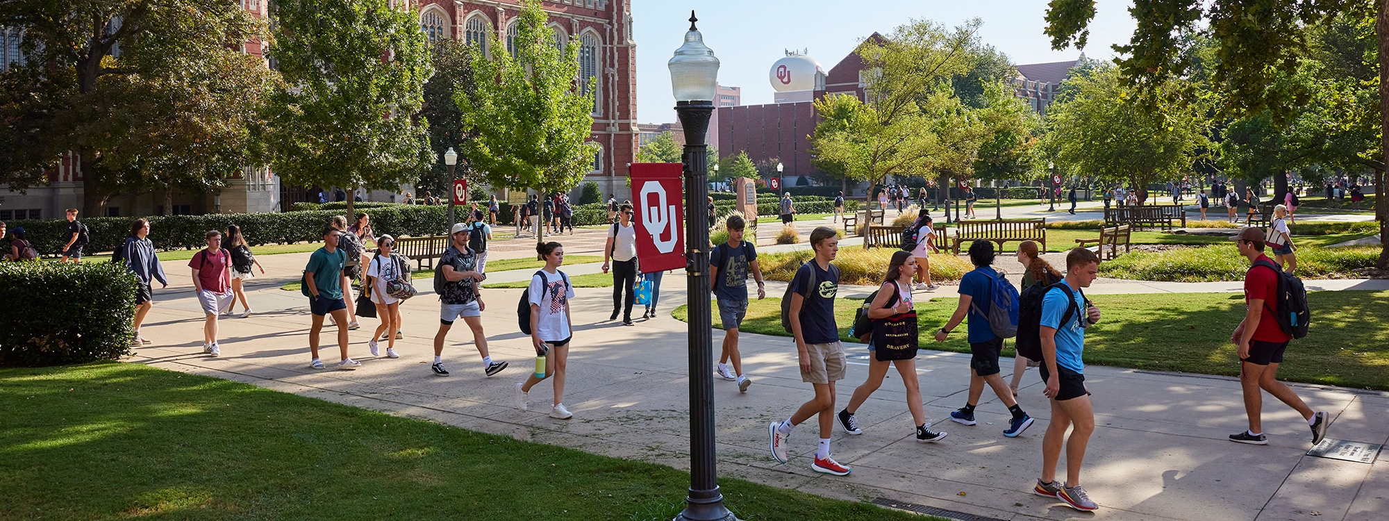 Students walking on a sunny day on the South Oval of the OU campus in Norman, Oklahoma.