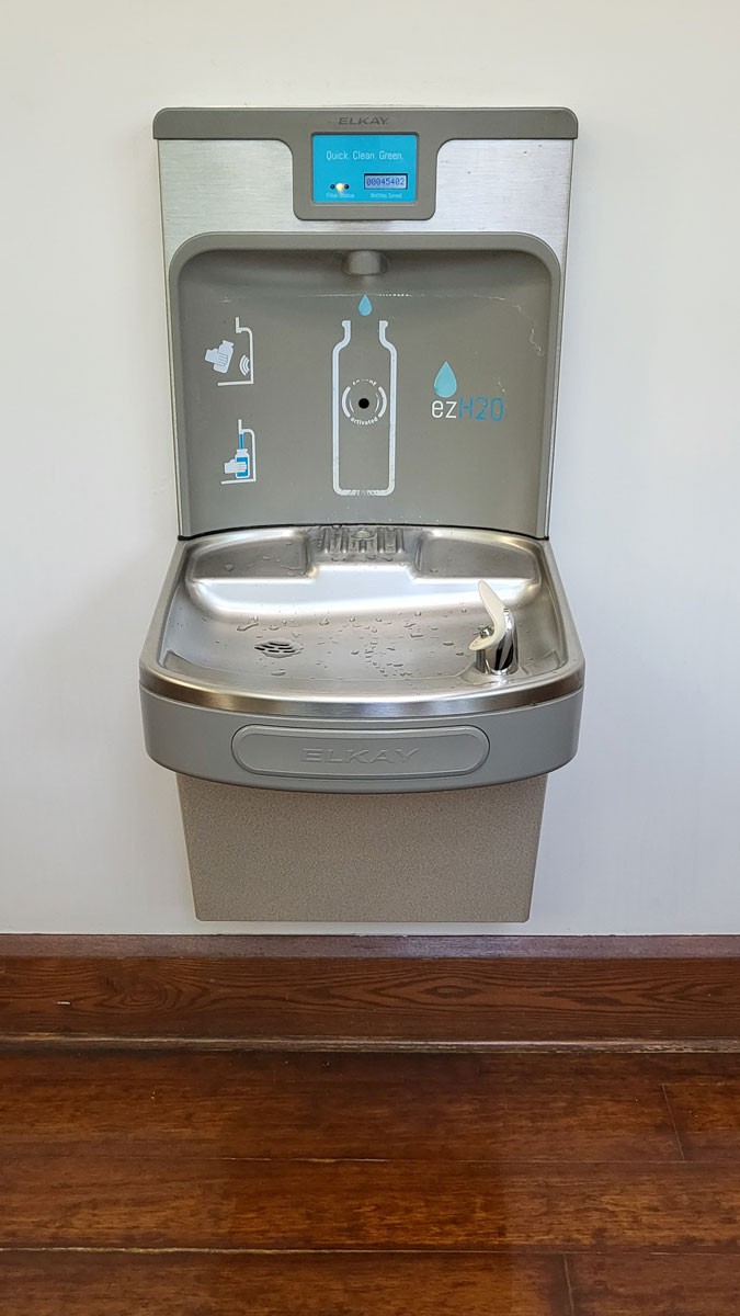 A water fountain featuring a water bottle filling station on top