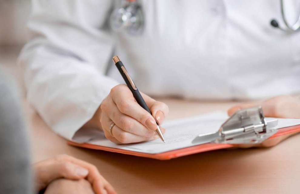 Doctor making notes about patient