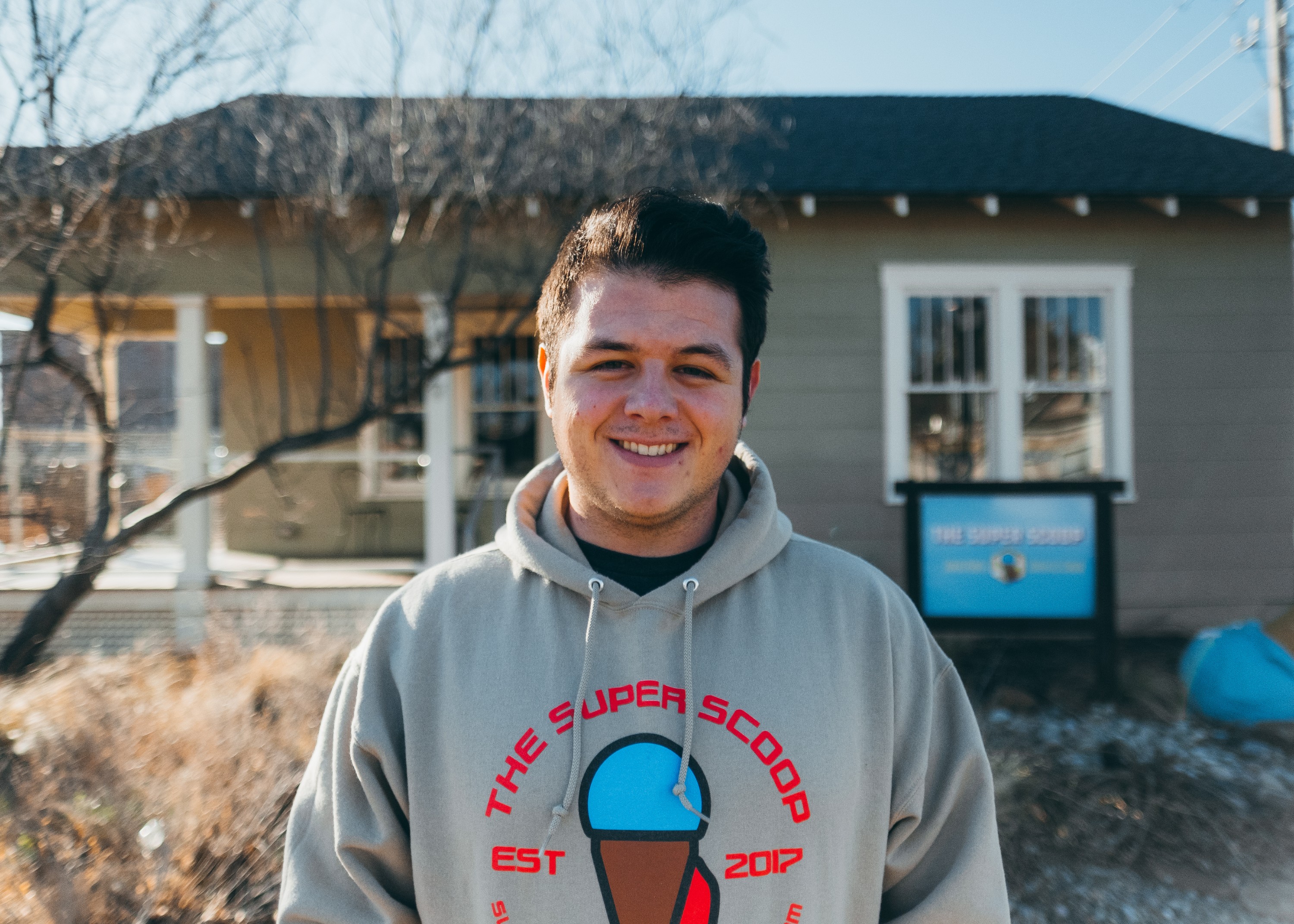 Riley Eden, an OU student, standing in front of the ice cream store he started