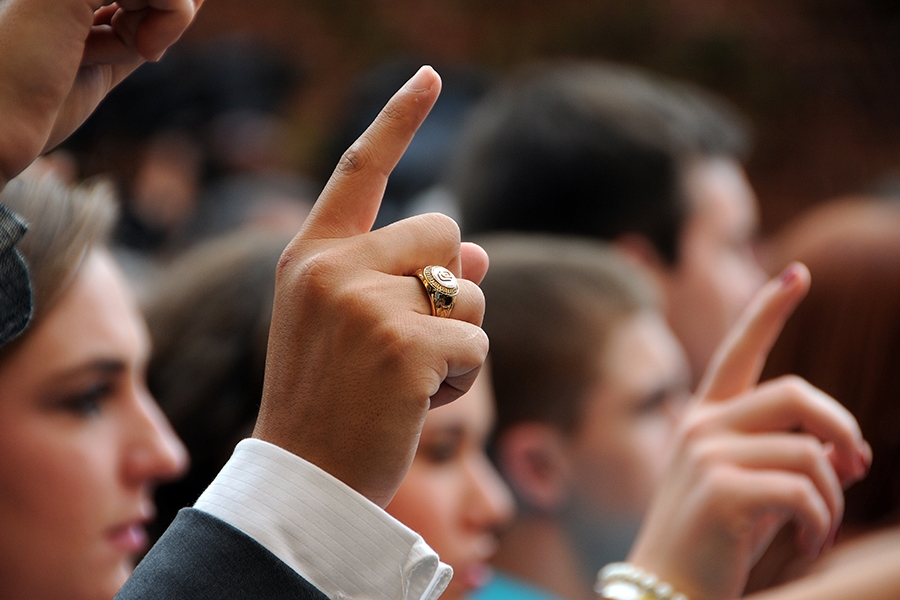 OU students hold up their pointer fingers at the OU ring ceremony.