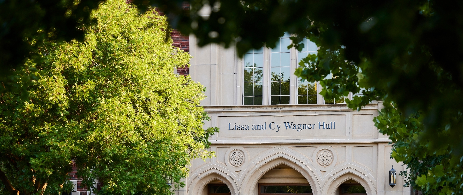 Wagner Hall with trees in front of the building.