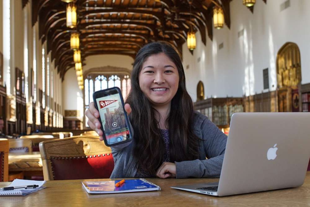 A faculty mentor talking to a group of students.