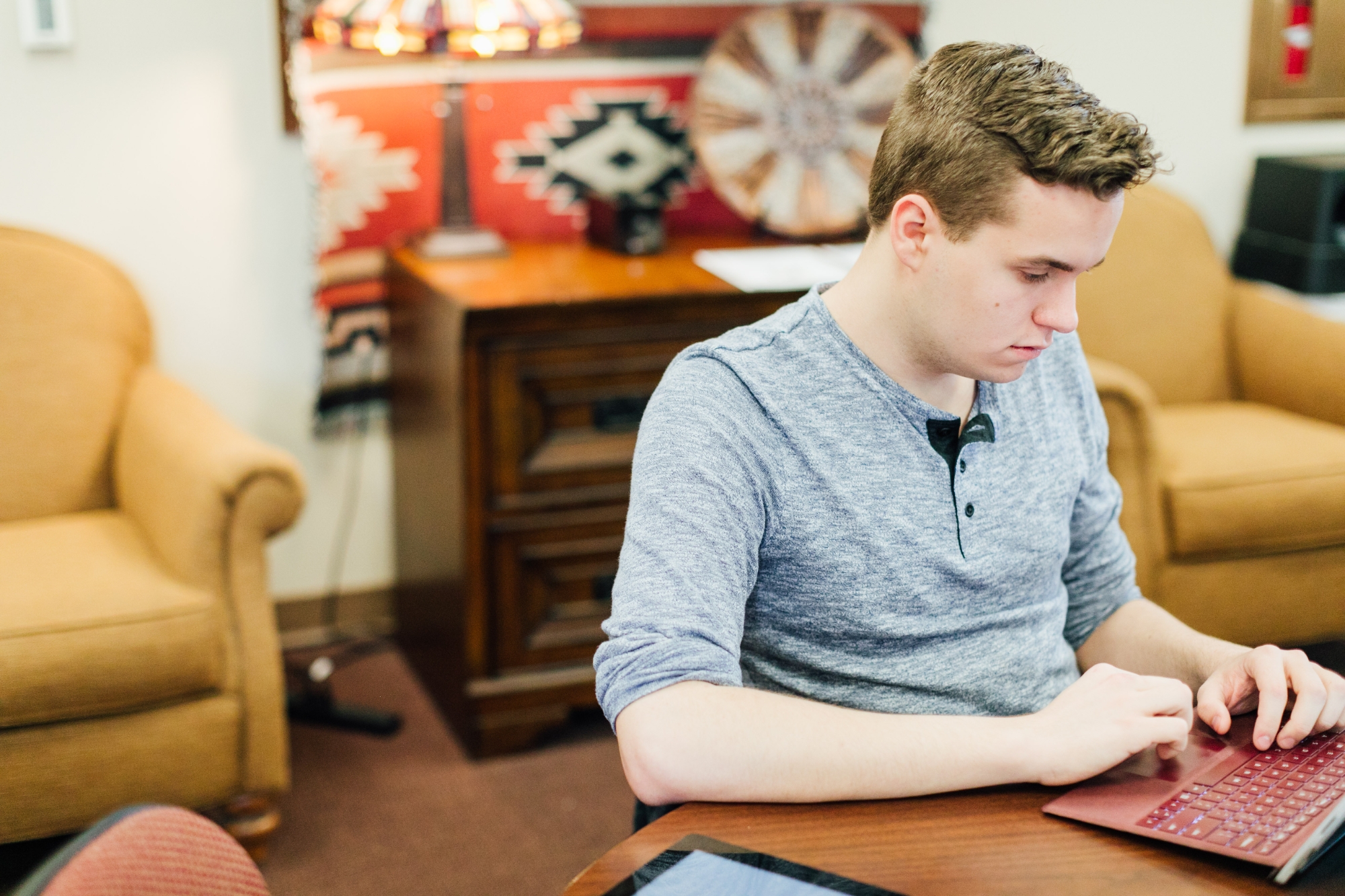 Students sit on the front row of a lecture hall taking notes