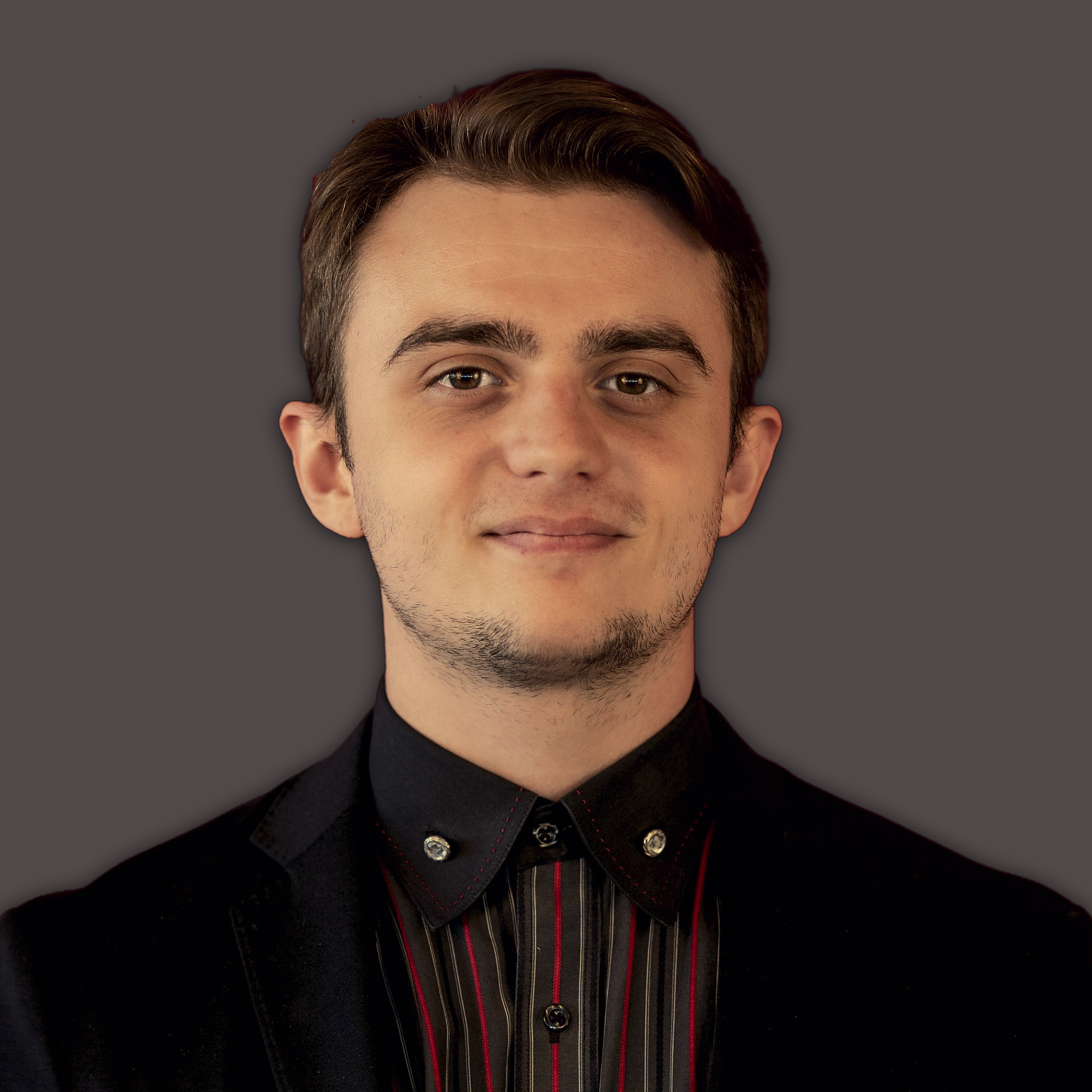 An O U flag on a lamppost, surrounded by greenery.
