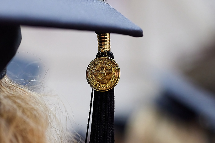 A graduation cap with the focus on the O U Tassel. 