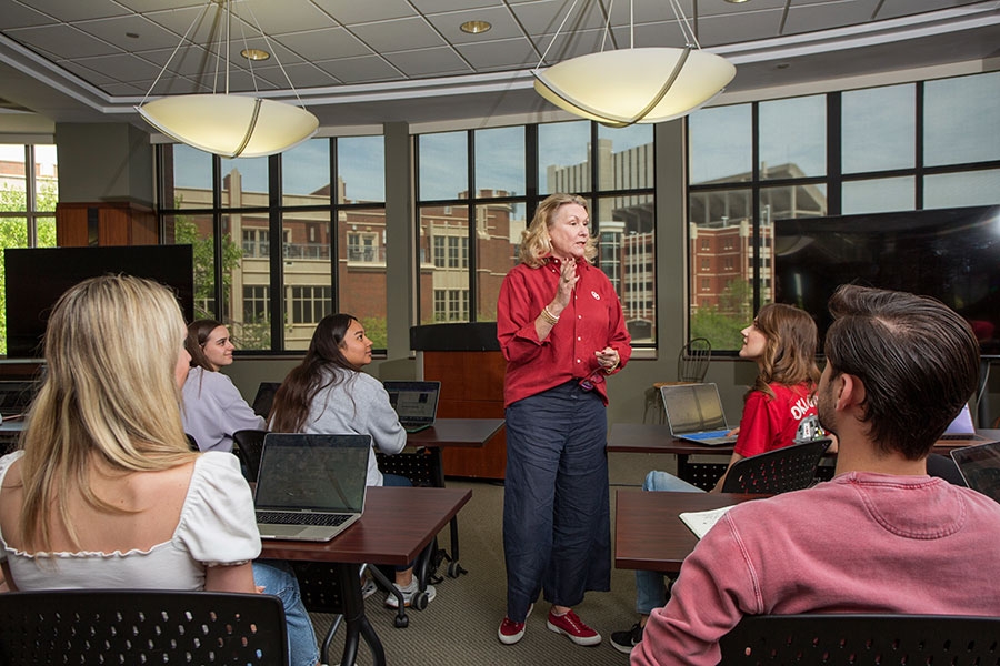 A professor giving a lecture to a room of students.
