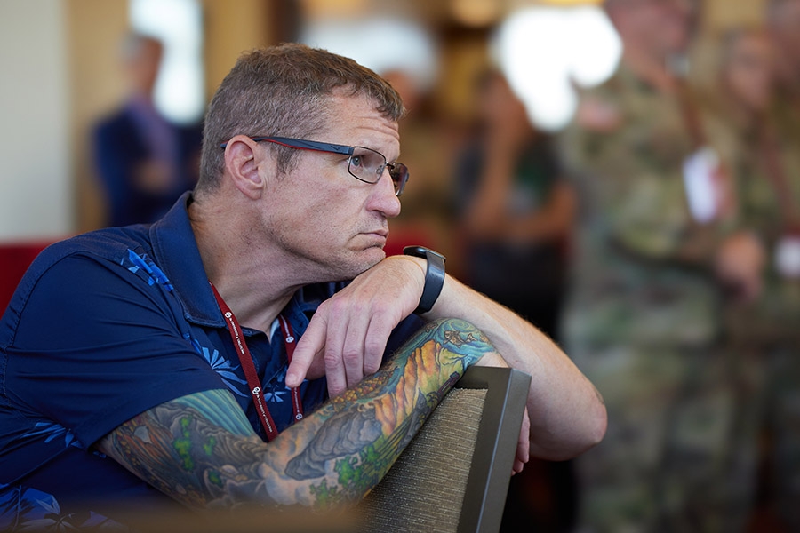 Attendee of the 2024 MVC Reception listens to the presentation during the event.