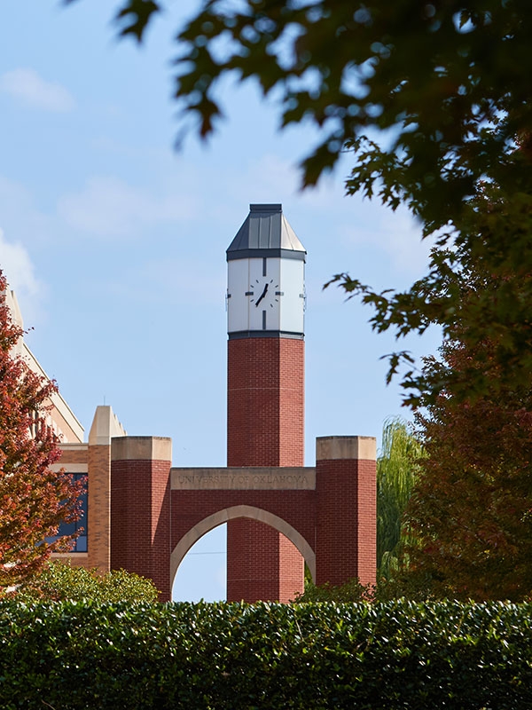 Clock tower on the O U Health campus, surrounded by greenery.