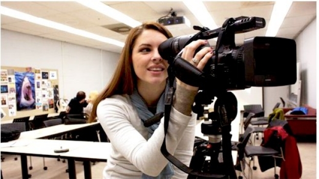 Student looking through video camera