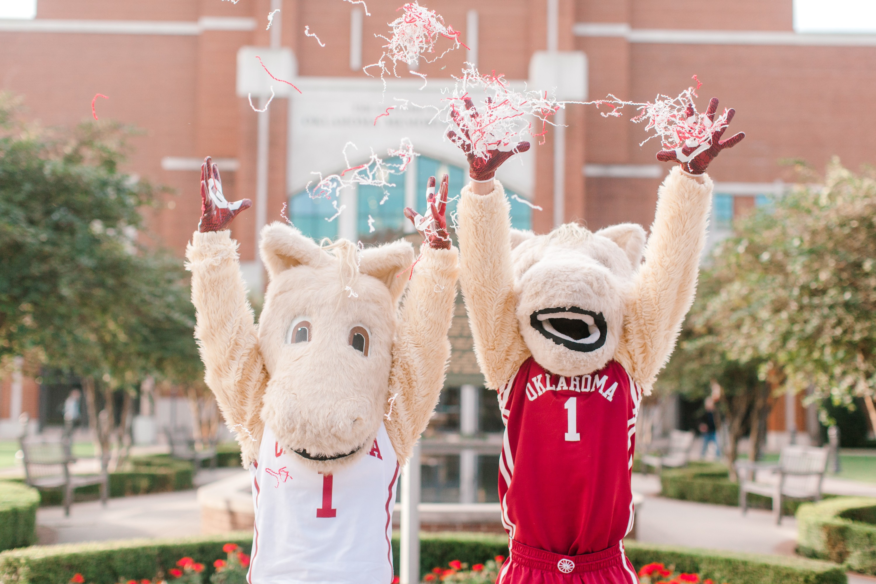 Boomer and Sooner mascots throwing confetti