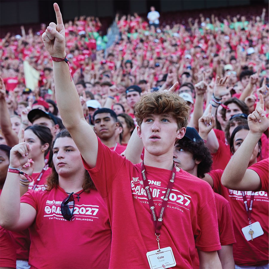 Class of 2027 students holding their pointer finger up while they attend Class Kickoff at the Gaylord Family - Oklahoma Memorial Stadium.
