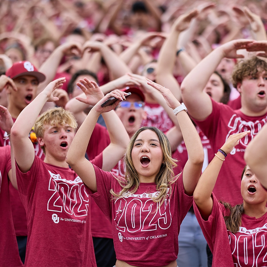 Class of 2027 students holding their pointer finger up while they attend Class Kickoff at the Gaylord Family - Oklahoma Memorial Stadium.