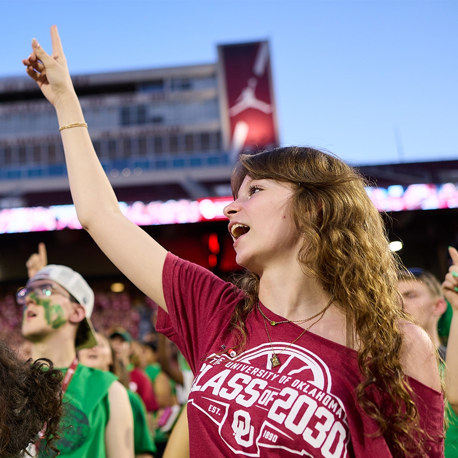 Class of 2027 students holding their pointer finger up while they attend Class Kickoff at the Gaylord Family - Oklahoma Memorial Stadium.