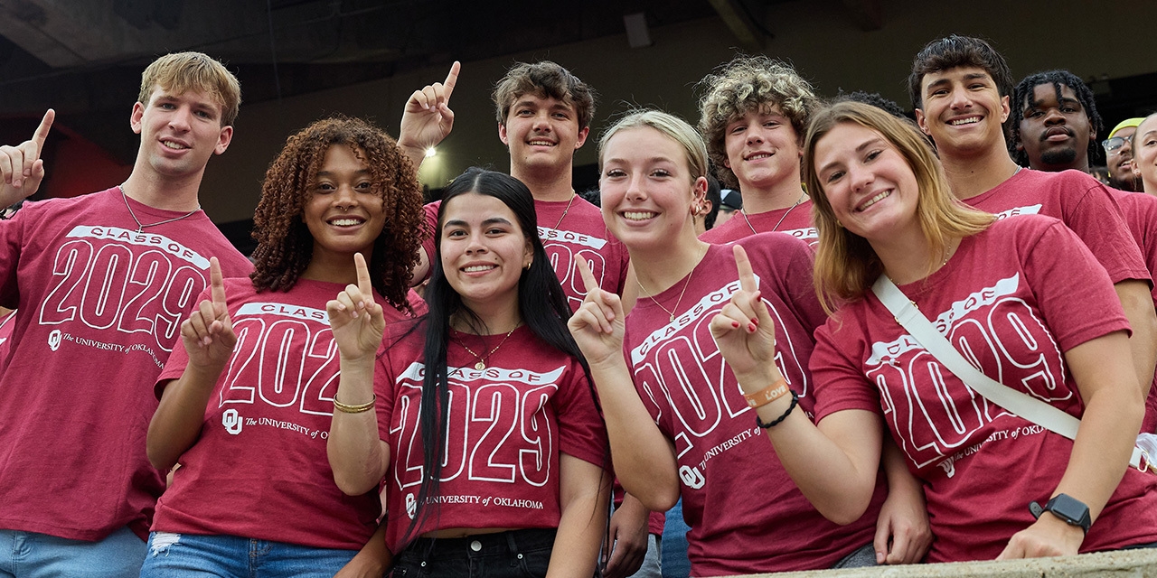 Students from the class of 2027 hold a crimson sign that says "Largest Class in OU's History" while celebrating Class Kickoff, held at the Gaylord Family - Oklahoma Memorial Stadium.